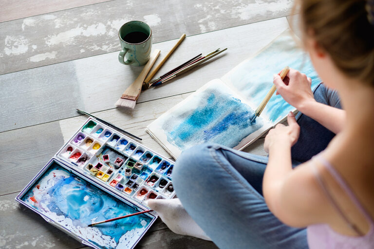 Woman painting as part of an art therapy program