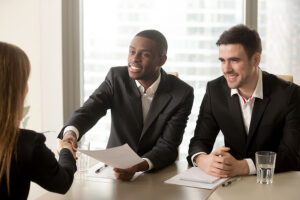 I/O psychologists meeting at a conference table.